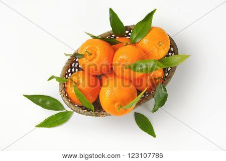 scuttle of ripe tangerines on white background