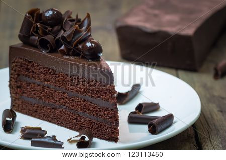 Chocolate Cake Topping With Chocolate Curl On Wood Background