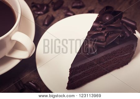 Chocolate Cake Topping With Chocolate Curl On Wood Background, Vintage Toning