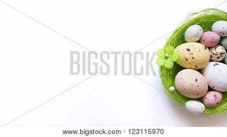 An Easter background with some realistic looking chocolate easter eggs and a basket.