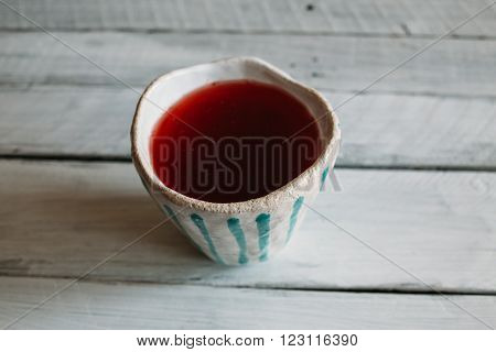 A White Ceramic Cup Tumbler With Mint Stripes ceramic cup with strawberry juice.