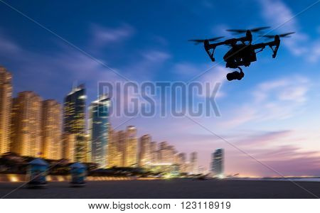 Drone silhouette flying above Dubaicity panorama