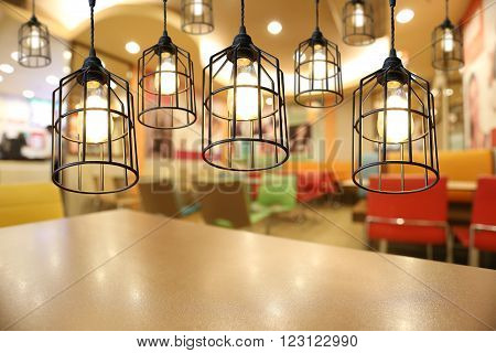 Warm lighting modern ceiling lamps in the cafe and interior decoration restaurant.