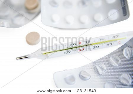 Among the open packages of tablets is mercury thermometer which shows a high temperature of 38.5 degrees