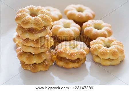 Sweet crispy pineapple biscuit and cookie scatter over with sweet sugar in white plain plate ready to eat/ Sweet crispy pineapple biscuit with sugar