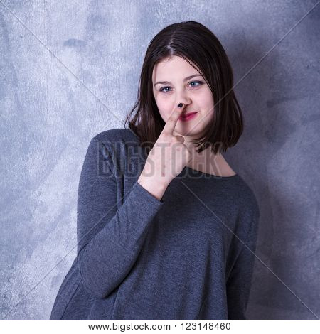 Teen Girl In Studio Posing On A Dark Background
