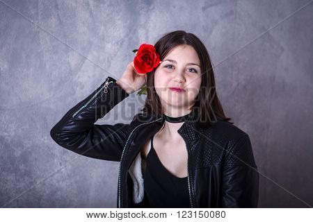 Teen Girl On A Dark Background In Leather Jacket With Red Roses