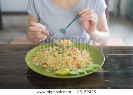 a girl eating Fried rice on soft focus