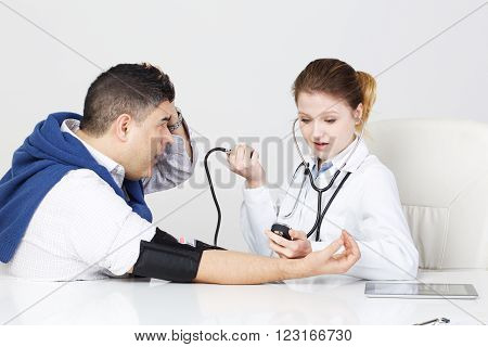 beautiful young woman Doctor checking patient pressure