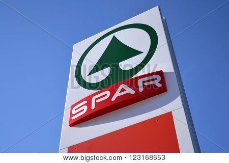 MATREI IN OSTTIROL, AUSTRIA - MARCH 28: Dutch multinational retail chain and franchise Spar logo with blue sky in background on March 28, 2012 in Matrei in Osttirol, Austria. The organization comprises over 12 000 stores in 40 countries.