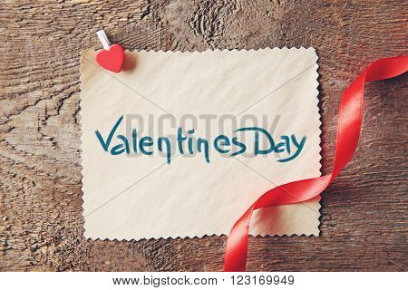 Blank present Valentine card on wooden background