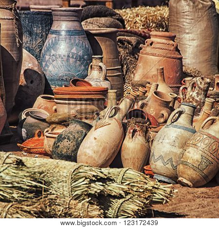 Differently sized dusty Clay pots stuck together at the village market in Moroccan town Ouarzazate