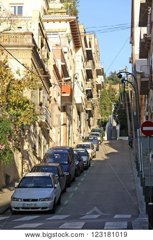 Barcelona, Catalonia, Spain - December 12, 2011: Road To Park Guell In Barcelona With Parked Cars