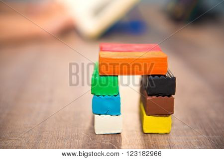 Little House of plastic clay on the wooden table