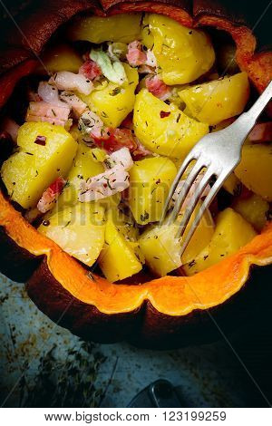 Baked pumpkin with potato and bakon on rural background .selective focus