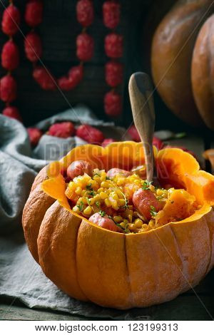 stew from pumpkin with salami sausages in the whole pumpkin on rural background .selective focus
** Note: Shallow depth of field