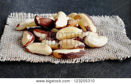 Brazil Nuts (close-up shot) on stone background. Bertholletia.