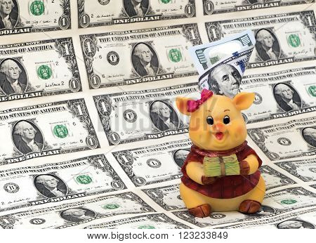 Piggy bank with money from ceramics in the notes on the background of the feet.