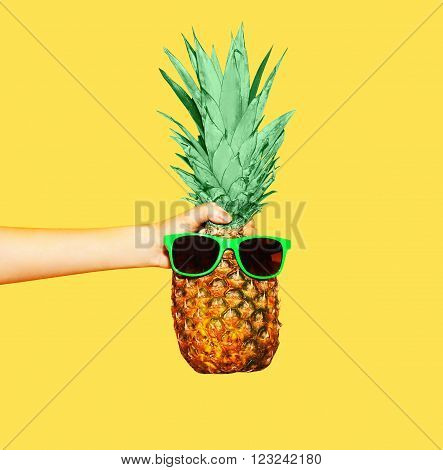Fashion Pineapple With Sunglasses On Yellow Background, Hand Holding Ananas