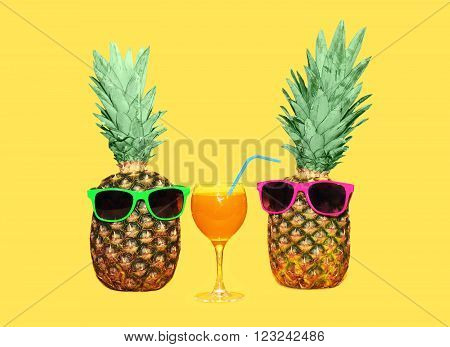 Two Pineapple With Sunglasses And Glass Fruit Juice On Yellow Background, Colorful Ananas