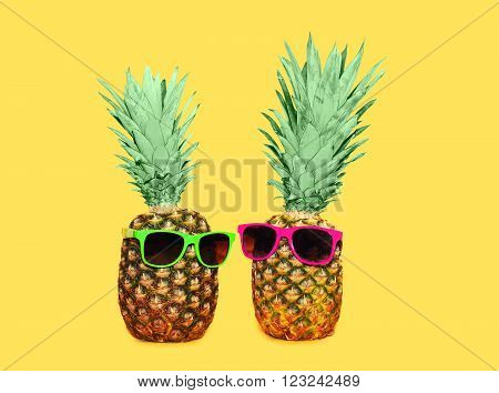 Two Pineapple With Sunglasses On Yellow Background, Colorful Ananas Concept