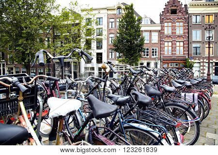 AMSTERDAM; THE NETHERLANDS - AUGUST 16; 2015: Lots of bicycles parked at the bike parking in Amsterdam. Amsterdam is capital of the Netherlands on August 16; 2015.