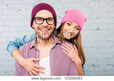 Beautiful Young Woman In Cap Embracing Her Boyfriend