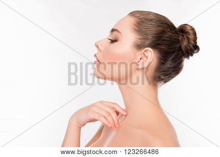 Side View Of Pretty Woman Touching Her Neck On White Background