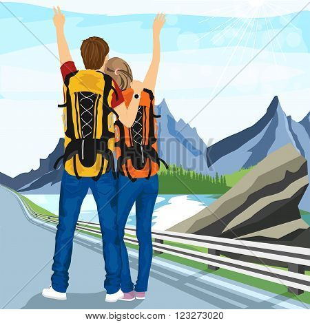 rear view of young couple of hitchhikers standing on road and enjoying mountain scenery