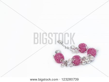 Pink beaded bracelet in the right corner