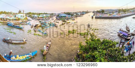 Soc Trang, Vietnam - February 3rd, 2016: Panorama landscape morning floating market wetland busiest night with boats transporting agricultural products to trade in this sunny morning preparing for the Lunar New Year in wetland Soc Trang, Vietnam
