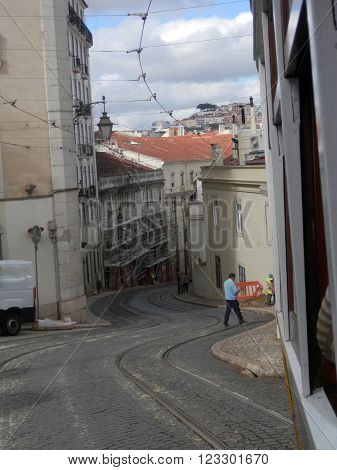 LISBON, PORTUGAL MARCH 15TH. Tramlines winding through narrow Lisbon street. Lisbon Portugal March 15th 2016