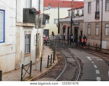 LISBON, PORTUGAL MARCH 15TH. Tramlines winding through narrow Lisbon street. Lisbon Portugal March 15th 2016