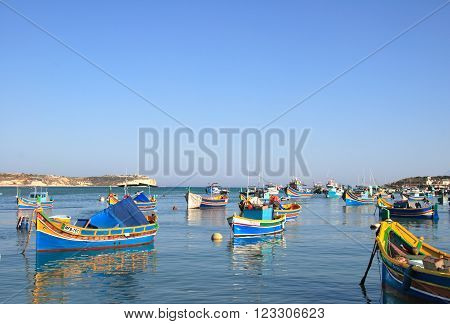 MARSAXLOKK, MALTA - JUNE 9, 2007: Colourful fishing boats in the Mediterranean on June 9, 2007 in Marsaxlokk, Malta.  Marsaxlokk is a famous traditional fishing village in Malta.