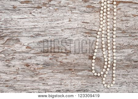 Vintage Background With Bead Necklace On The Old Wood