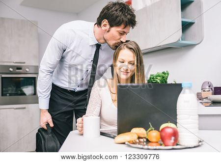 Husband kissing goodbye to his wife before going to work
** Note: Shallow depth of field