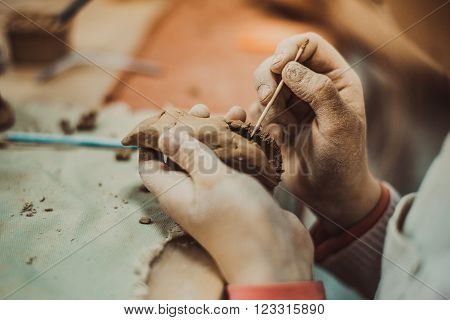 children's hands sculpts clay crafts pottery school