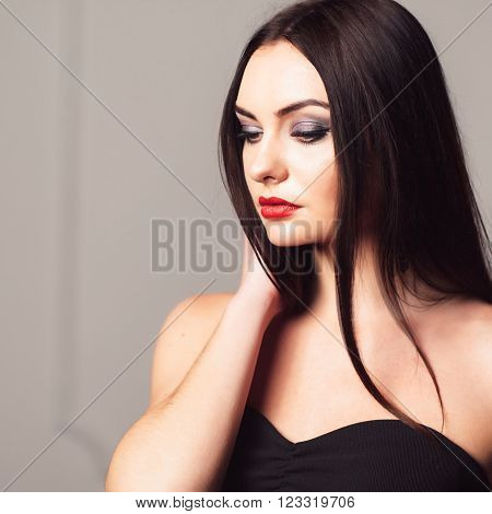 Young attractive woman with bright creative make-up. Sexy girl with creative make-up. Studio shoot of thoughtfull brunette.