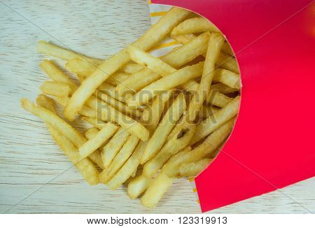 French fires in red box on a wood background.