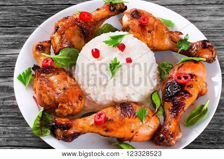 Rise and Grilled chicken sticky drumsticks marinated with honey and ginger top-view