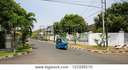 JAKARTA, INDONESIA - AUGUST 27, 2015: betjak is driving through Kayu Putih neighbourhood in Jakarta, Indonesia