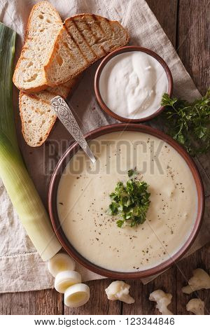 Cauliflower Puree Soup And Ingredients Close-up. Vertical Top View