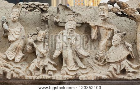 Vintage sculptures with life of ancient sages on carved wall of Wat Pho temple Bangkok. Buddhist temple complex founded in 16th century
