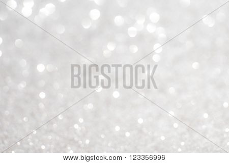 Silver white glittering Christmas lights. Blurred abstract background