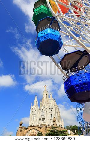 BARCELONA SPAIN - SEPTEMBER 15 2014: Ferris Wheel and Church in Mount Tibidabo, Barcelona, Spain