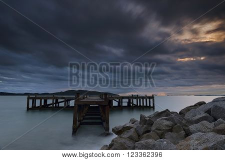 Old iron bridge black cloud at seaside.