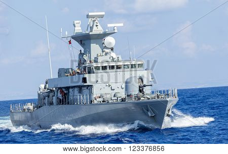 a little warship drives fast in ocean