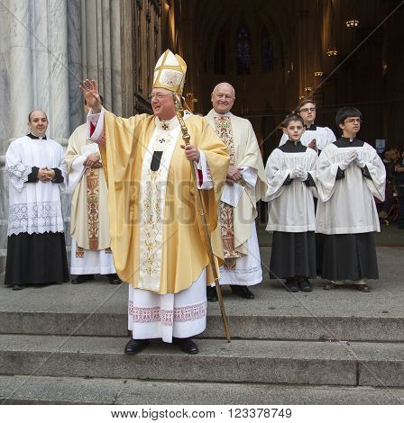 New York NY USA - March 27 2016: Archbishop of New York Cardinal Dolan greets worshipers and guests on the steps of Saint Patrick's Cathedral in Manhattan after Easter mass