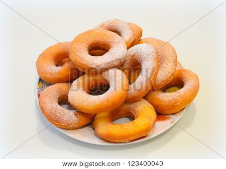 Bagels fried in deep fat with powde