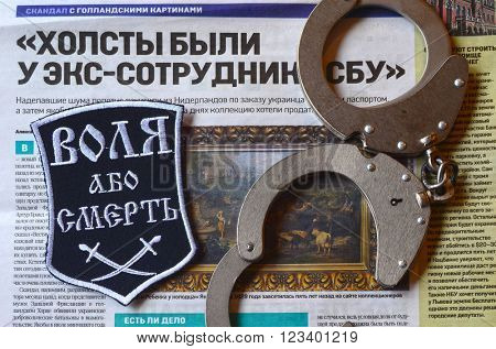 Kiev,Ukraine.FEB 20.ILLUSTRATIVE EDITORIAL.Chevron Ukrainian nazionalist battalion.Background - newspaper about West Frisian stolen art . February 20,2016 in Kiev, Ukraine